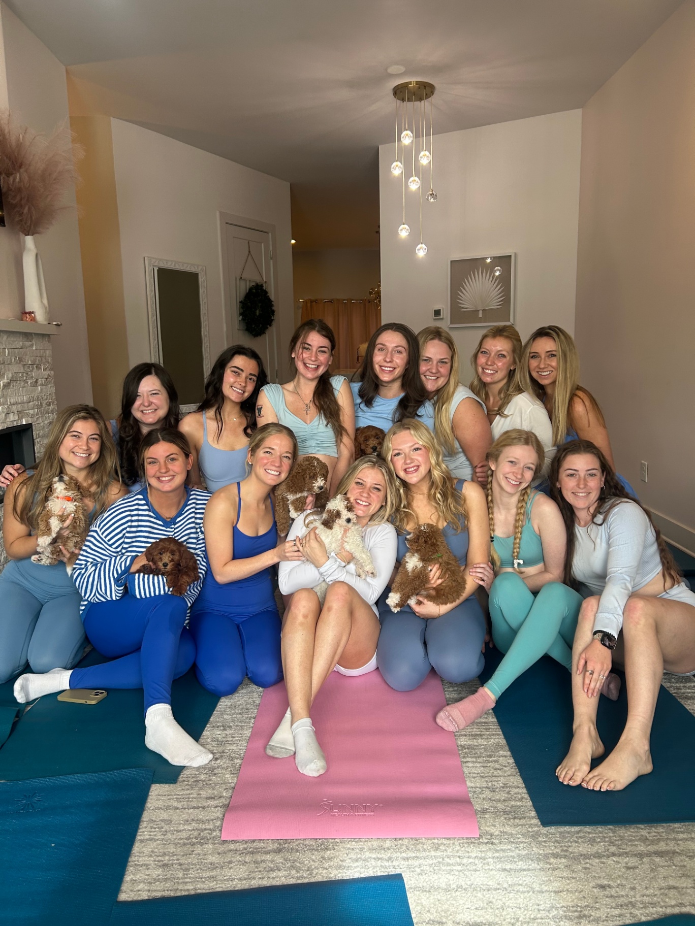 Large Nashville group in matching blues holding puppies after class